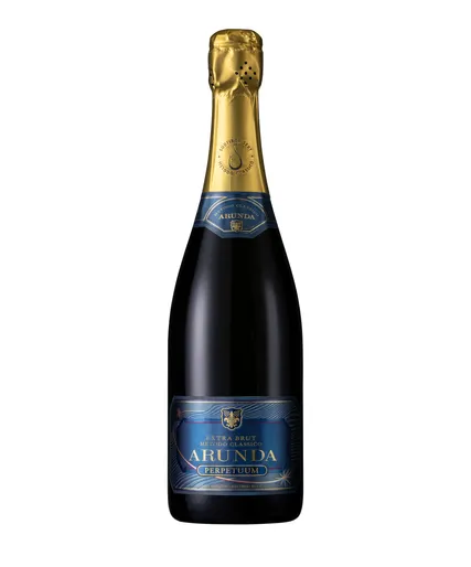 Arunda Perpetuum Extra Brut mit tiefblauem Etikett, goldenen Akzenten, Sternenmotiv und blauer Halsschleife, Produktfoto