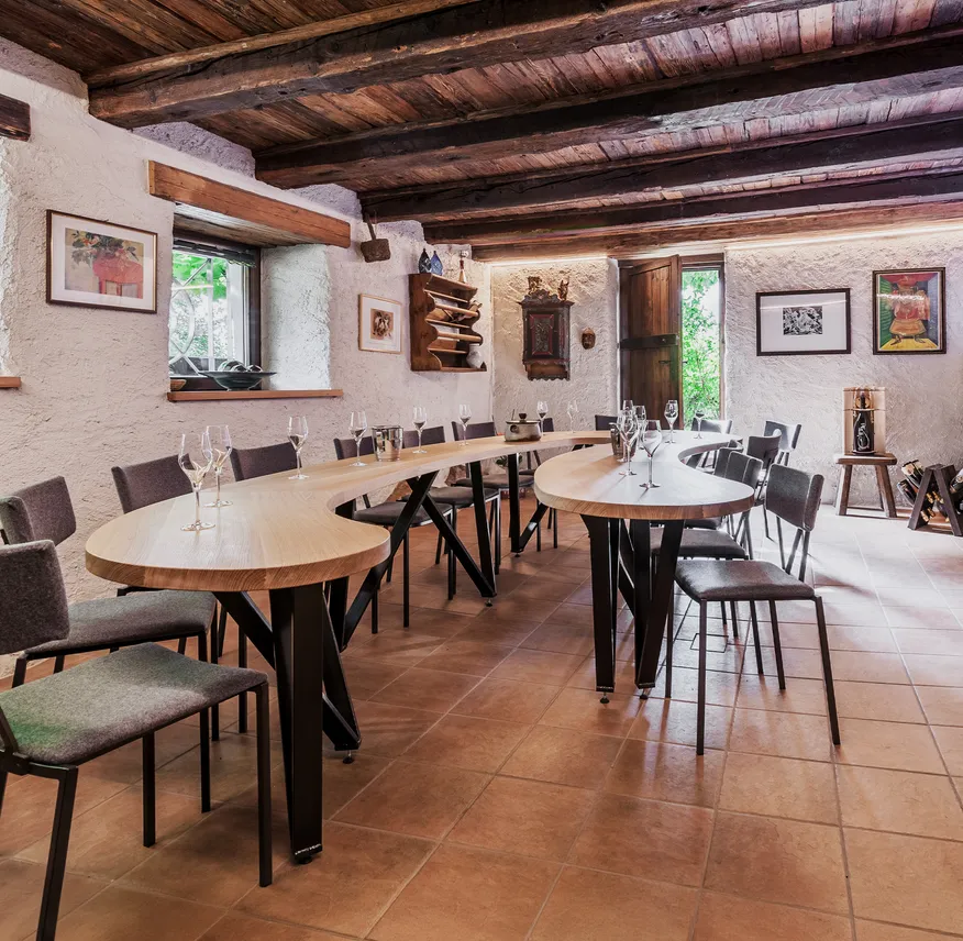 Verkostungsraum mit gewölbter Holzbalkendecke, S-förmigem Eichentisch, gepolsterten Stühlen und Sektgläsern, Mölten